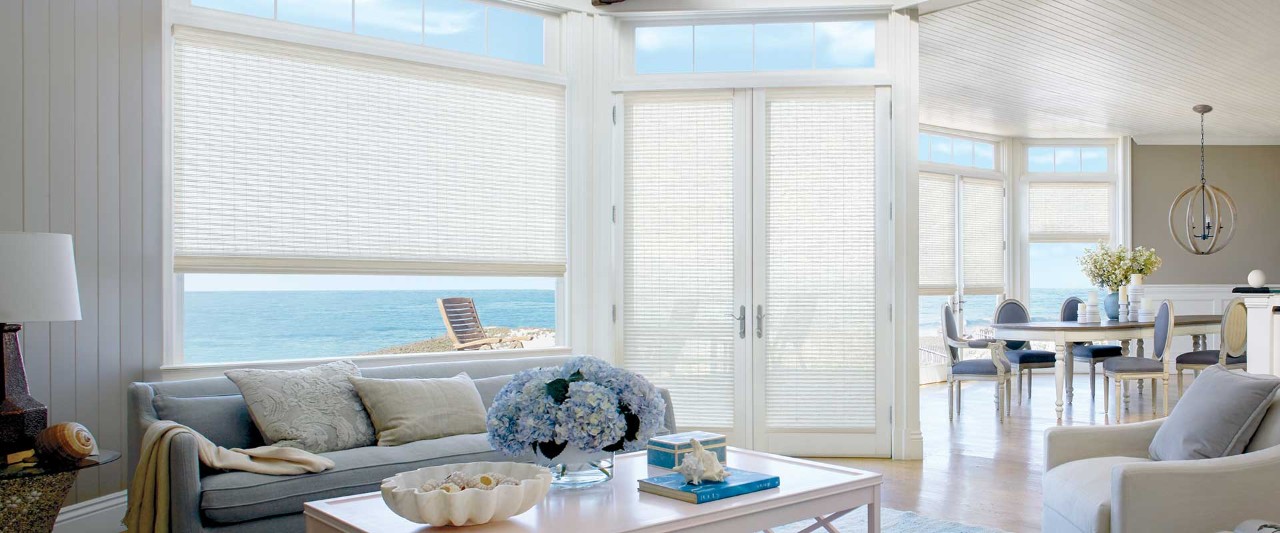 Coastal living room with woven shades.